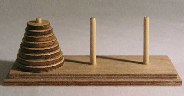 There are three wooden poles representing the towers.  The first has
10 rings on it, with the largest at the bottom and the smallest on top.